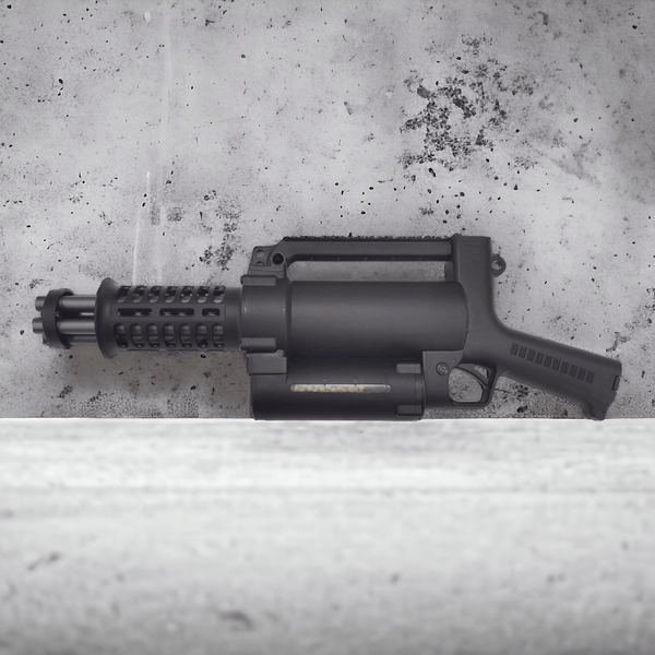 M134 Mini Vulcan Gatling Gel Blaster showcasing its lightweight nylon design and rotating barrels on a concrete background.